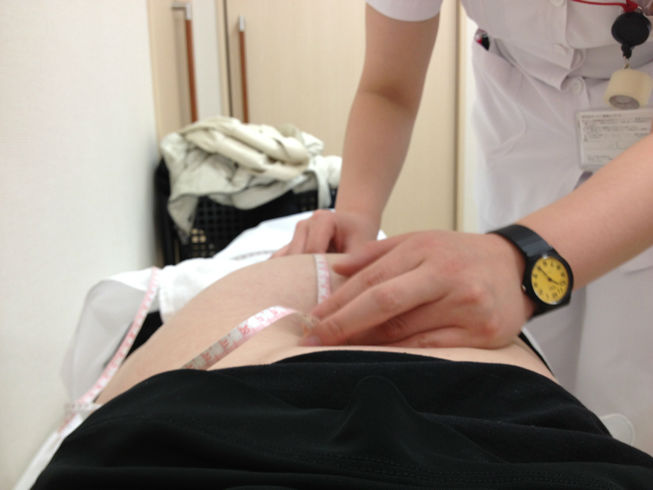 Midwife measuring uterus