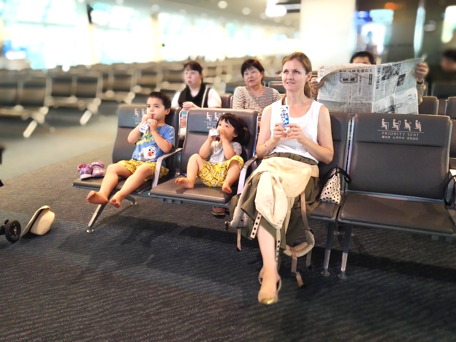 Waiting for our plane to board. We bought some milk from the vending machine and watched the TV to keep the kids entertained!